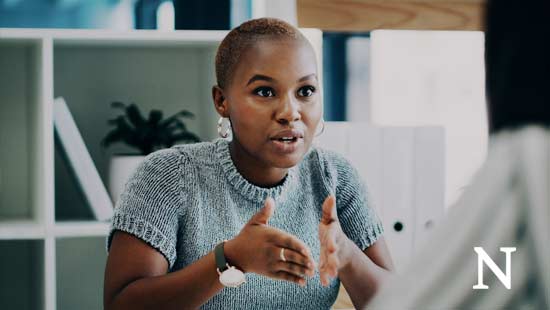 seated woman speaking emphatically