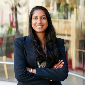 Alex Ramnarine, Northwestern SPS alum, graduated with her master's in Data Science from Northwestern University. She is smiling, crossing her arms in a professional pose, and is wearing a blazer 