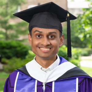Pardhu shares his experience in the Master's in Public Policy and Administration program at Northwestern University. He wears his Northwestern graduation cap and gown with the green Evanston campus behind him.