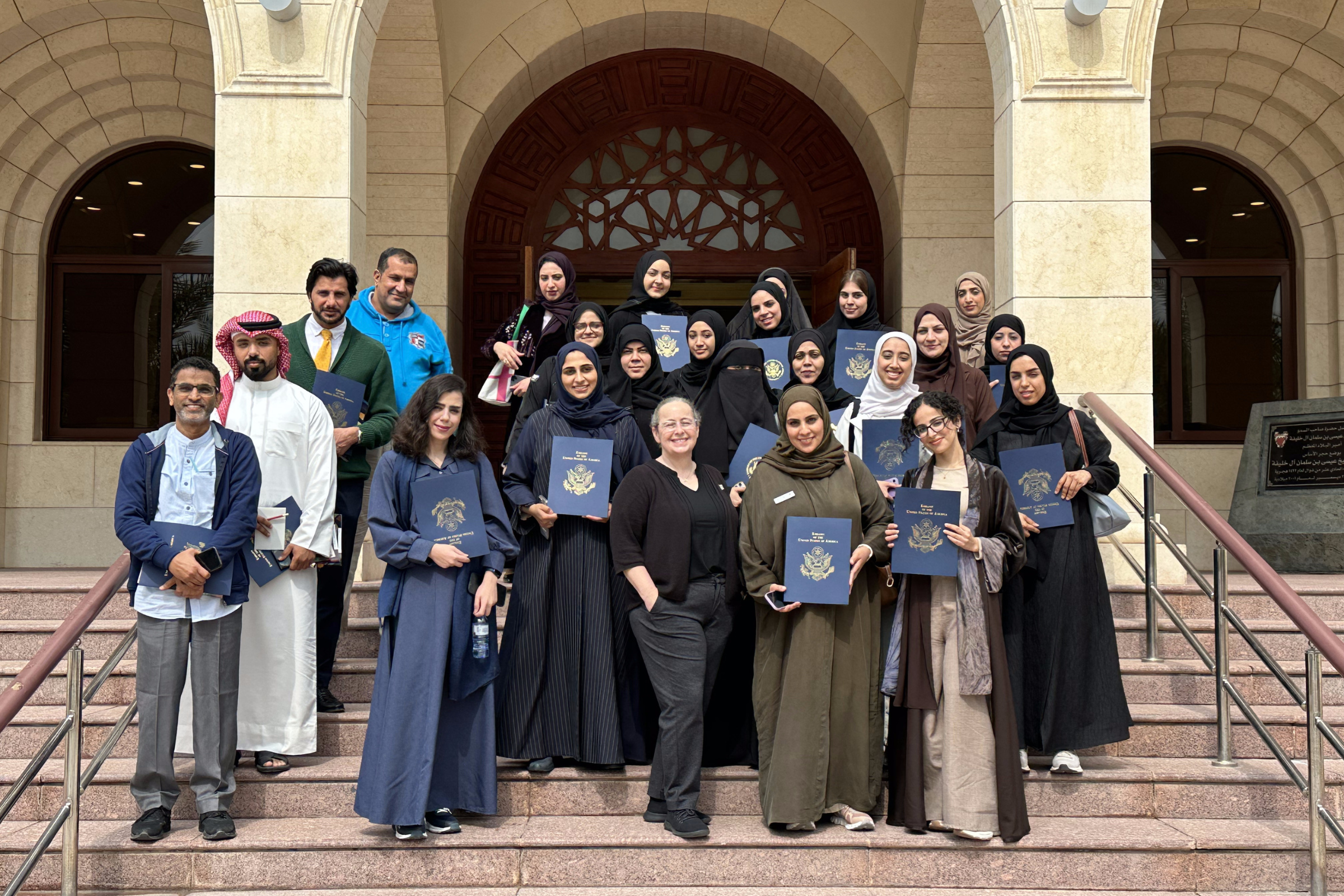 Christine Fiorite (center) with Bahraini educators holding certificates after completing English language teaching workshops